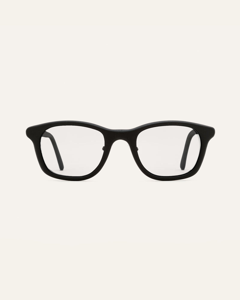 Blonde woman wearing minimalist black prescription glasses, perfect for eco-conscious professionals in London.