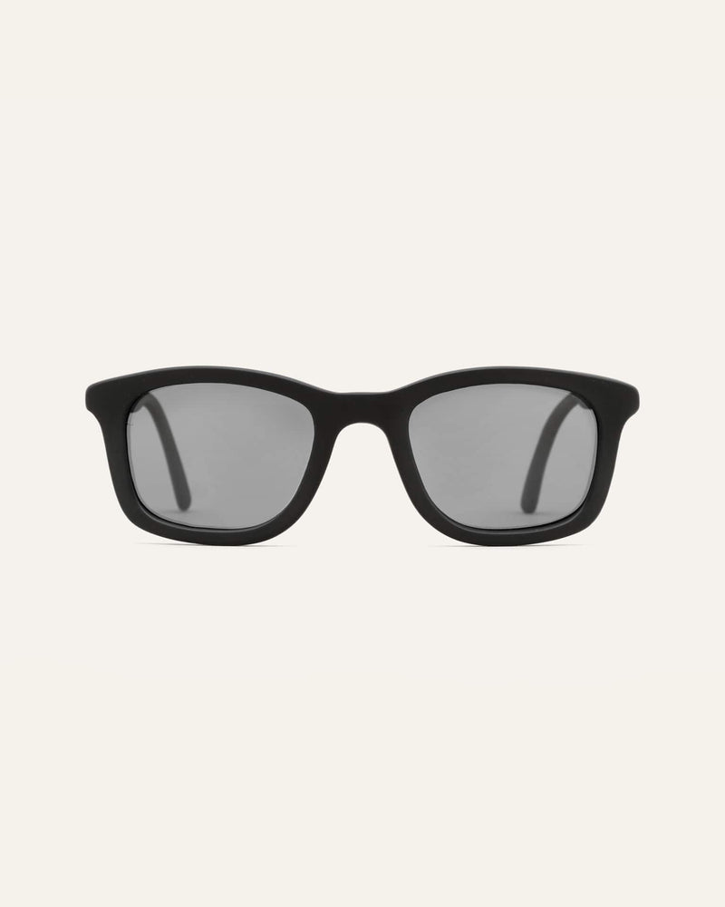 Man wearing eco-friendly coffee sunglasses with gray sun protective lenses