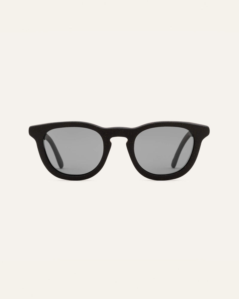 Man wearing Anderson Black sunglasses, showcasing their timeless design and deep black finish.