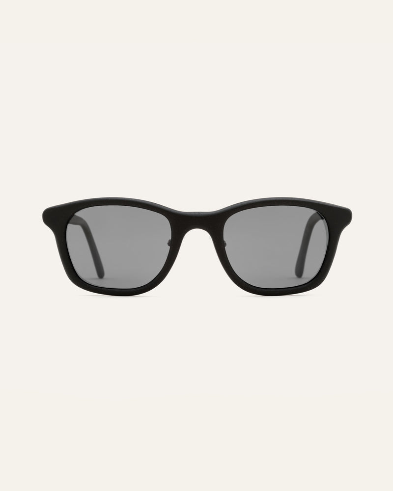 Blonde woman in eco-friendly sunglasses with gray lenses, ideal for sustainable fashion lovers in Scandinavia.