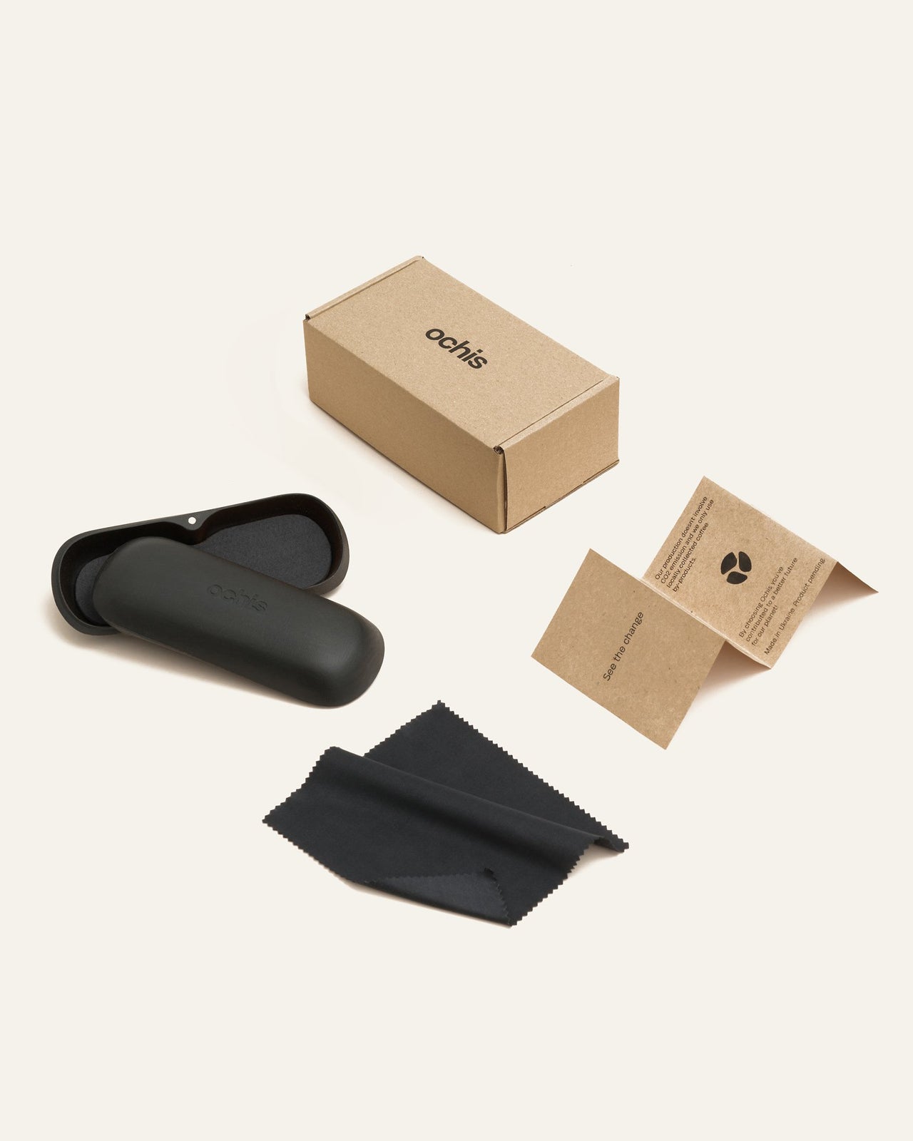 Laden Sie das Bild in den Galerie-Viewer, Complete set of black sunglasses with gray lenses, includes protective case, cleaning cloth, and eco-friendly packaging.