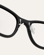 Close-up of black optical frames, highlighting their handcrafted quality and sustainable design.