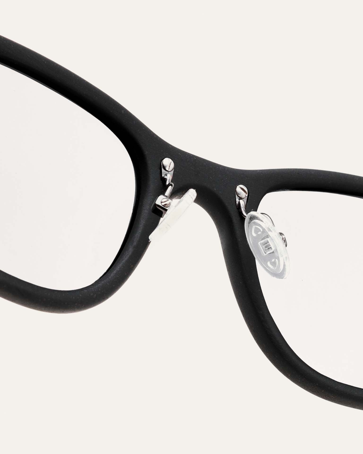 Close-up of black optical frames, highlighting their handcrafted quality and sustainable design.