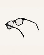 Detailed view of prescription glasses with polished black frames, crafted for fashion-forward individuals.