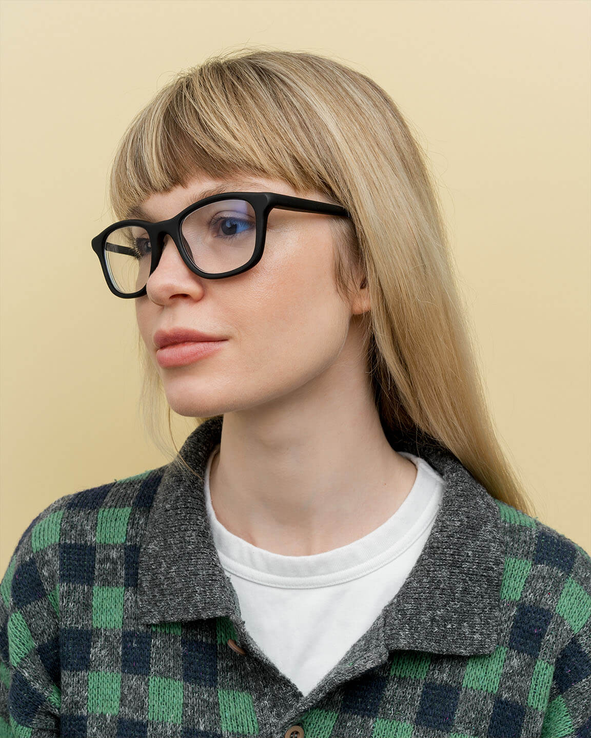 Load image into Gallery viewer, Blonde woman wearing minimalist black prescription glasses, perfect for eco-conscious professionals in London.
