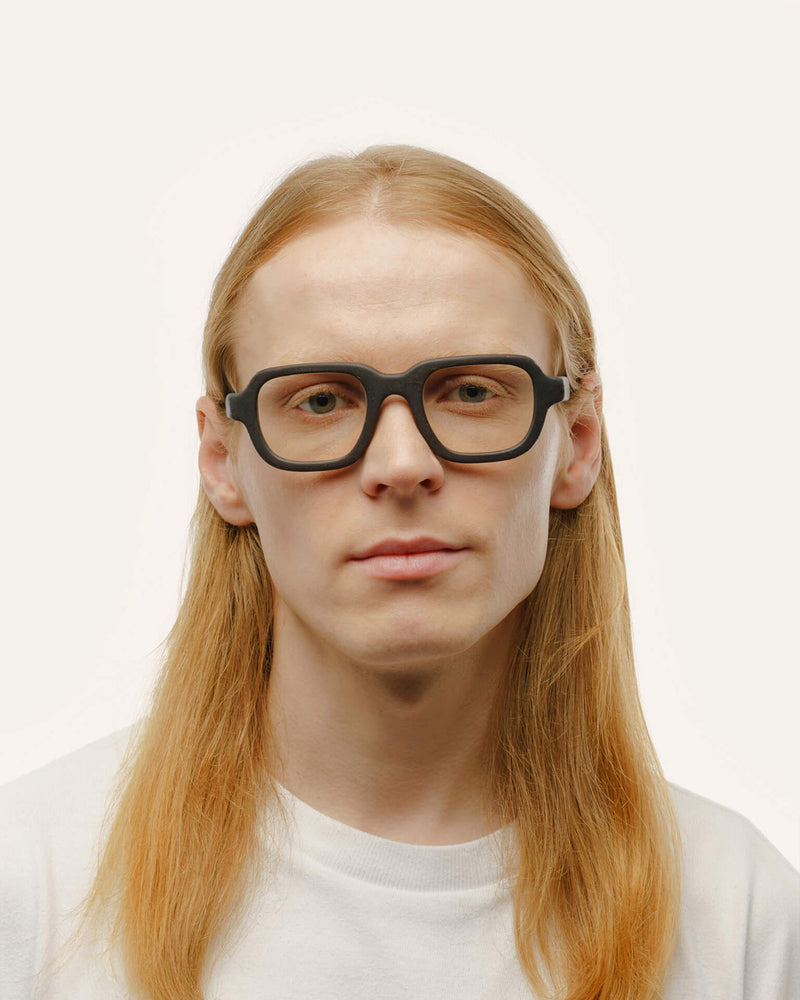 Black optical frames crafted from coffee-based materials, displayed on a neutral background.