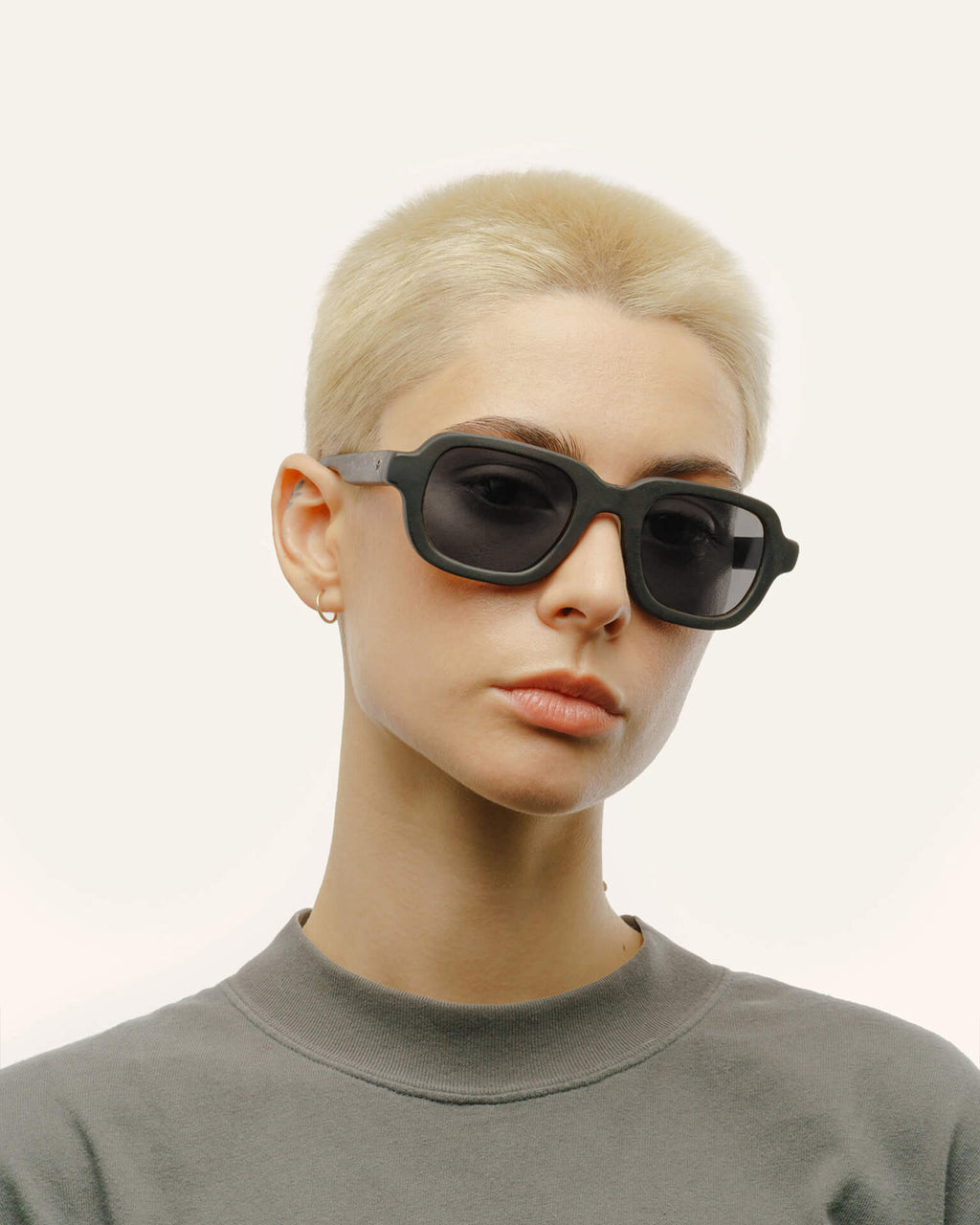 Woman in Ochis Brade sunglasses with gray lenses, emphasizing minimalist style and eco-conscious craftsmanship