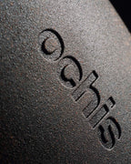 Close-up of the black coffee-based eyewear case, featuring a detailed view of the Ochis logo embossed on the surface