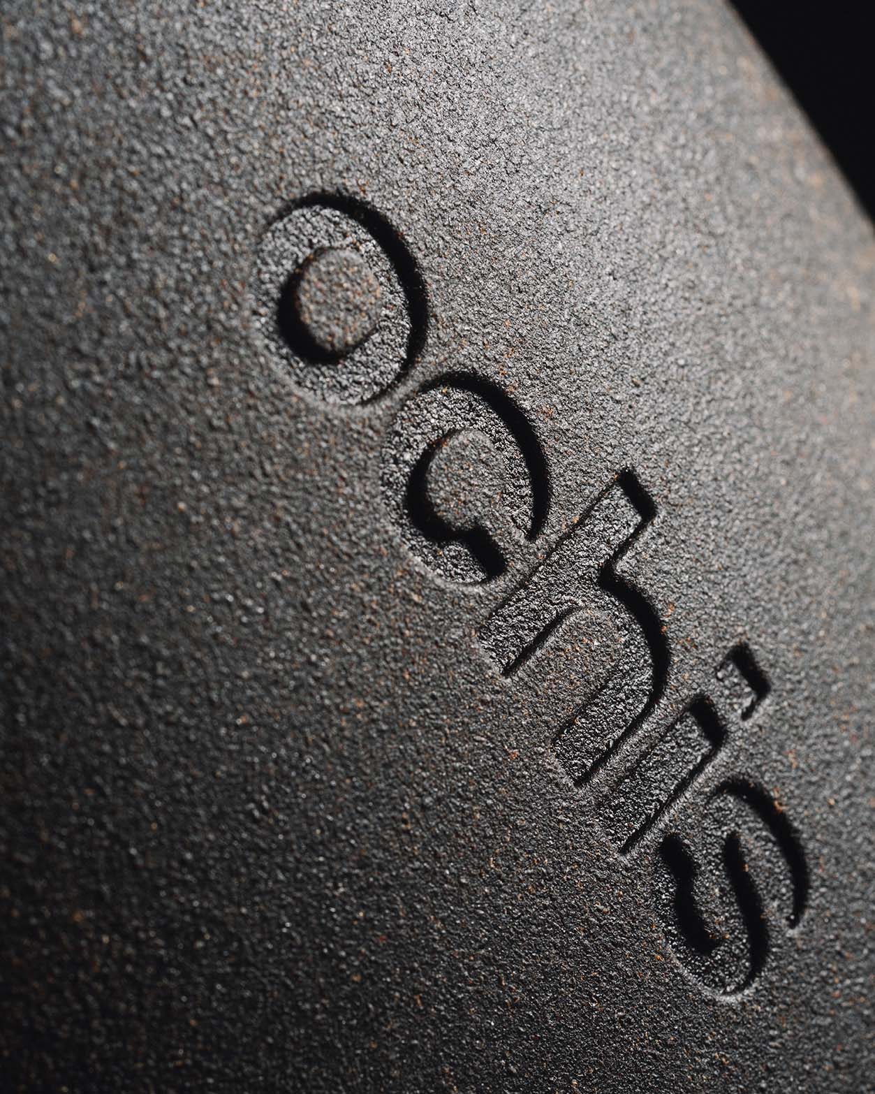 Close-up of the black coffee-based eyewear case, featuring a detailed view of the Ochis logo embossed on the surface