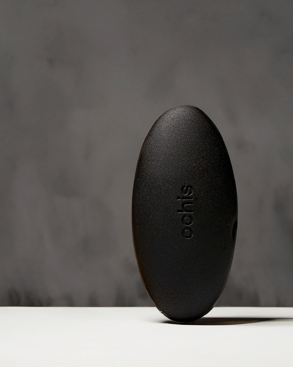 Black coffee-based glasses case standing vertically, highlighting its unique, nature-inspired shape and durable construction