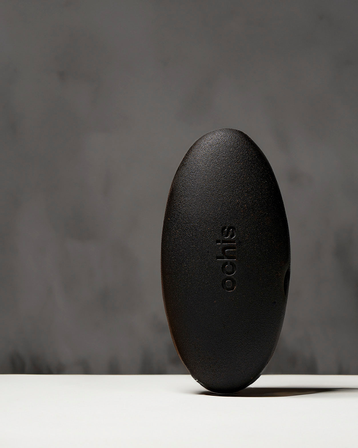 Black coffee-based glasses case standing vertically, highlighting its unique, nature-inspired shape and durable construction