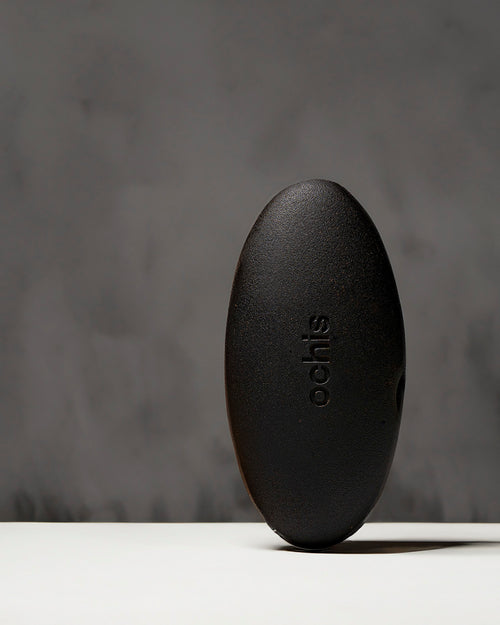 Black coffee-based glasses case standing vertically, highlighting its unique, nature-inspired shape and durable construction