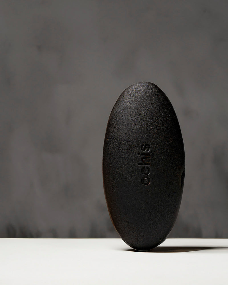 Black sustainable eyewear case made from coffee-based materials, displayed with eco-friendly packaging on a neutral background