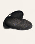 Black eco-friendly glasses case adorned with cornflower petals, highlighting its sustainable coffee-based design
