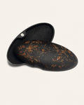 Open eco-friendly case made from coffee-based materials, adorned with vibrant marigold petals for a natural and artistic touch