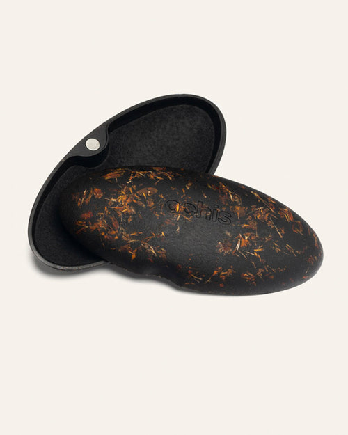 Open eco-friendly case made from coffee-based materials, adorned with vibrant marigold petals for a natural and artistic touch