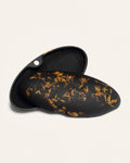 Open coffee-based case featuring delicate sunflower petals, blending eco-friendly design with a natural artistic flair