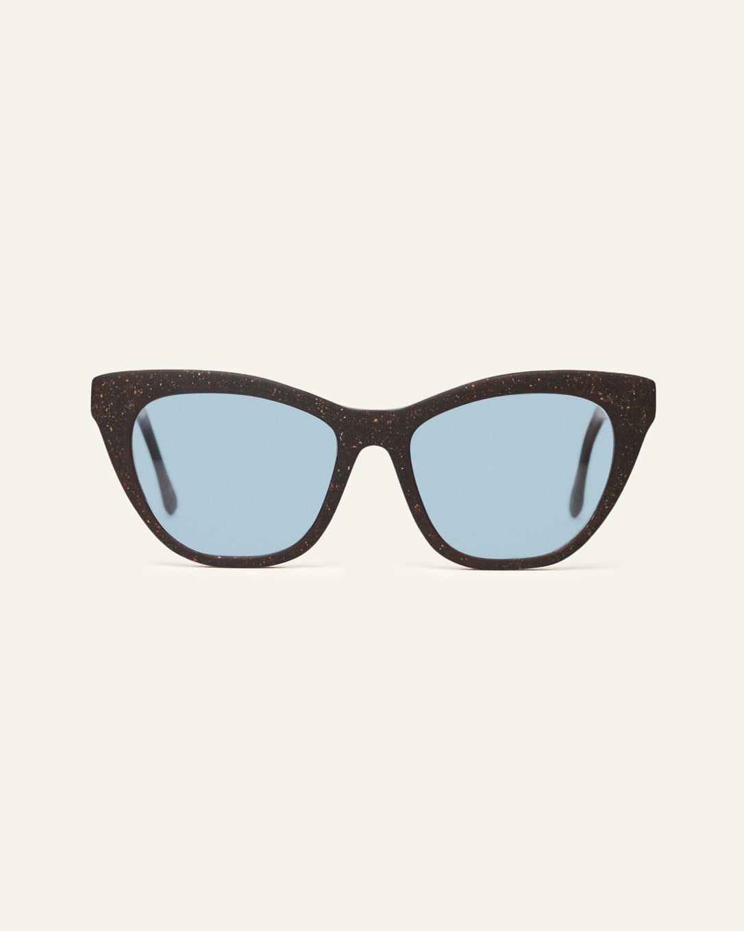 Front view of Define Flow cat-eye sunglasses with blue lenses and a brown coffee-based frame with visible walnut shell particles