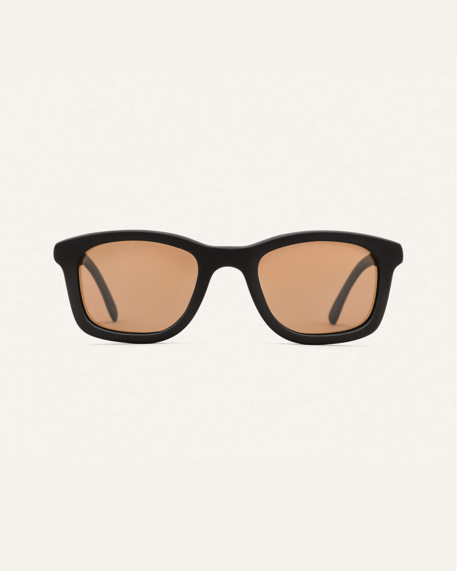 Dandy sunglasses with warm brown lenses on a white background, featuring a black coffee-based frame