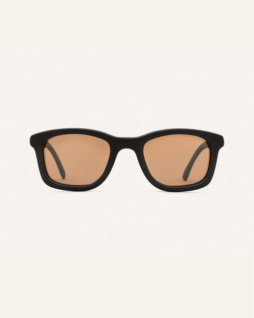 Dandy sunglasses with warm brown lenses on a white background, featuring a black coffee-based frame