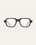 Black coffee-based optical frame with flax textures on a neutral background.
