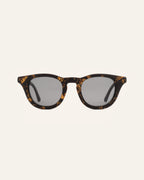 Sunglasses with gray lenses, crafted from coffee-based frames and accented with vibrant sunflower petals