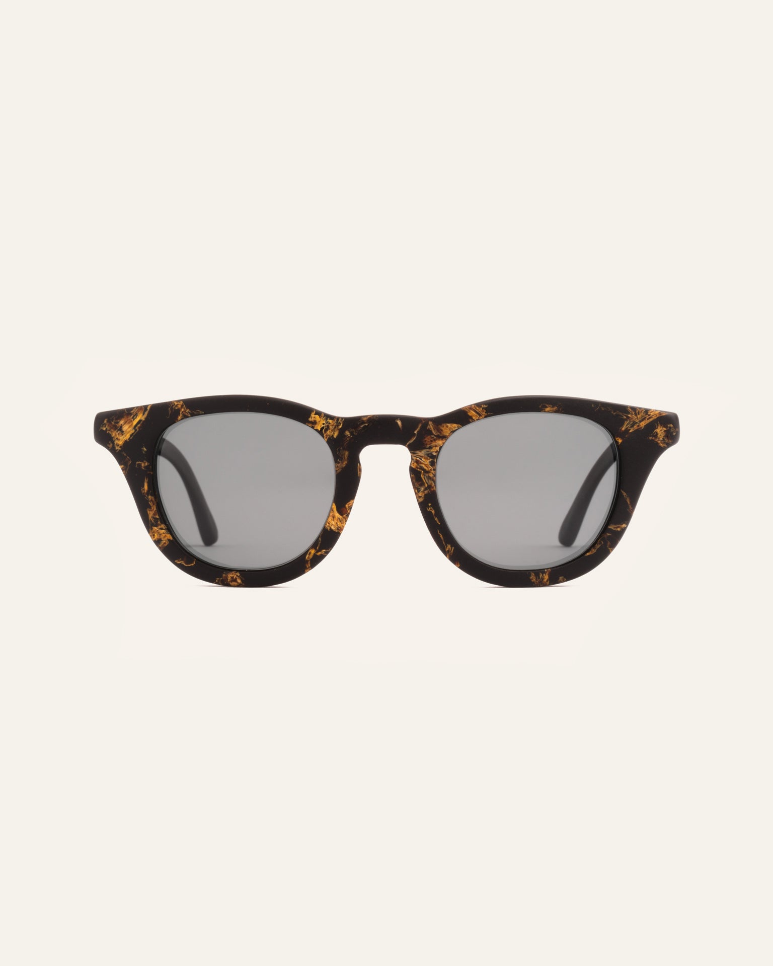 Sunglasses with gray lenses, crafted from coffee-based frames and accented with vibrant sunflower petals