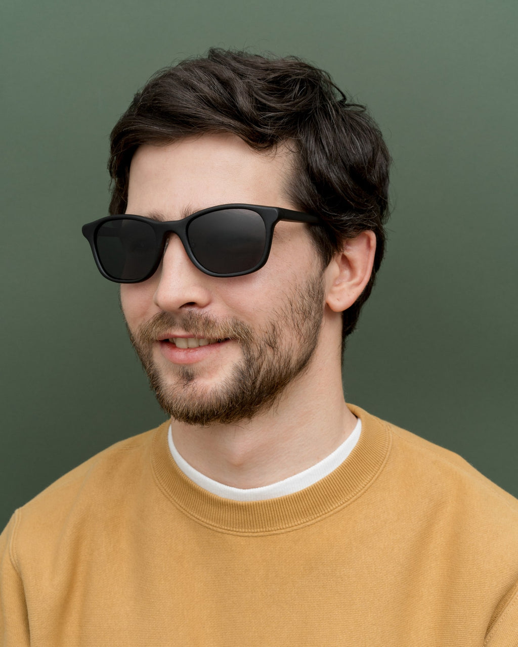 Man wearing lightweight coffee-based sunglasses with sleek gray lenses, perfect for minimalists in Germany.