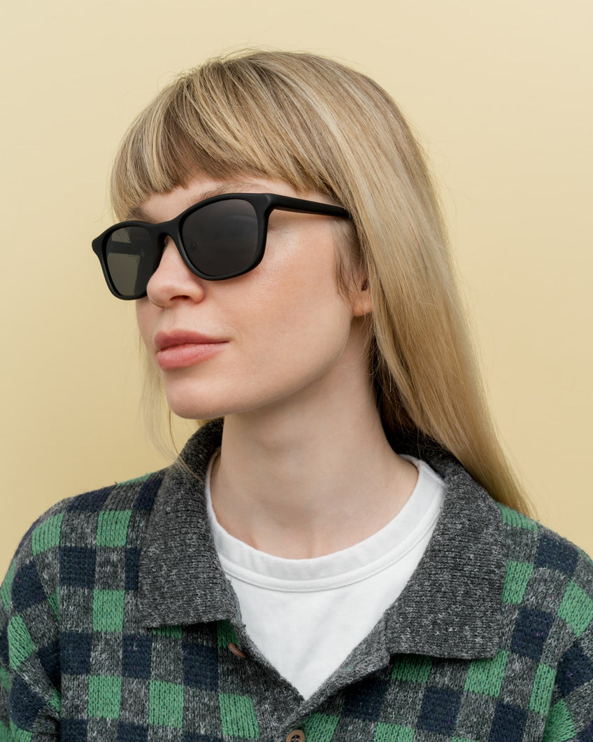 Blonde woman in eco-friendly sunglasses with gray lenses, ideal for sustainable fashion lovers in Scandinavia.
