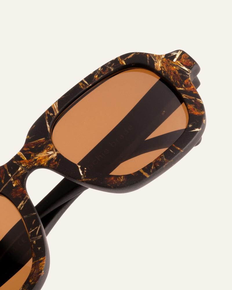 Sunglasses with brown lenses and a marigold-accented coffee-based frame