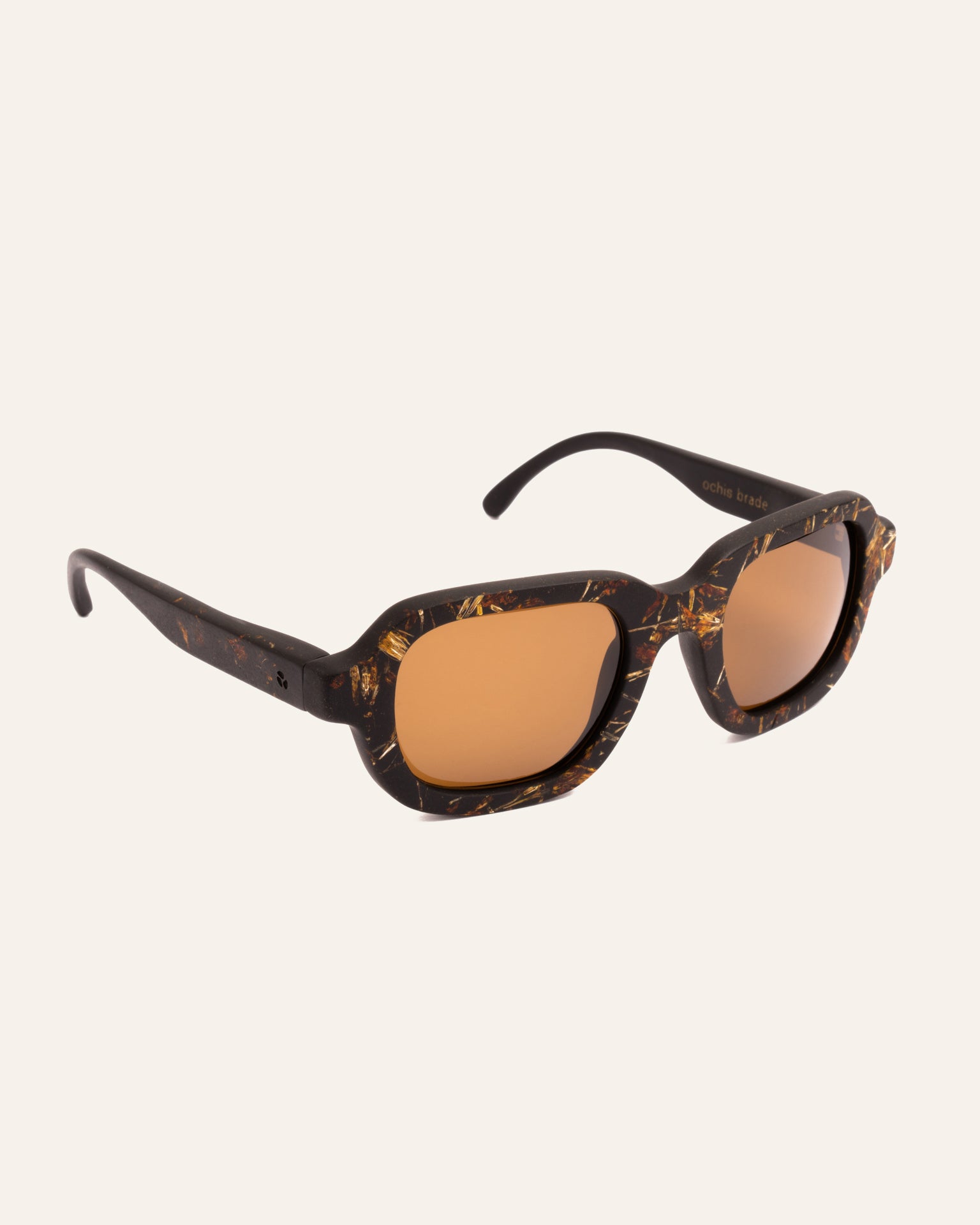 Angled view highlighting the sustainable design of marigold-embedded black frames with brown lenses.
