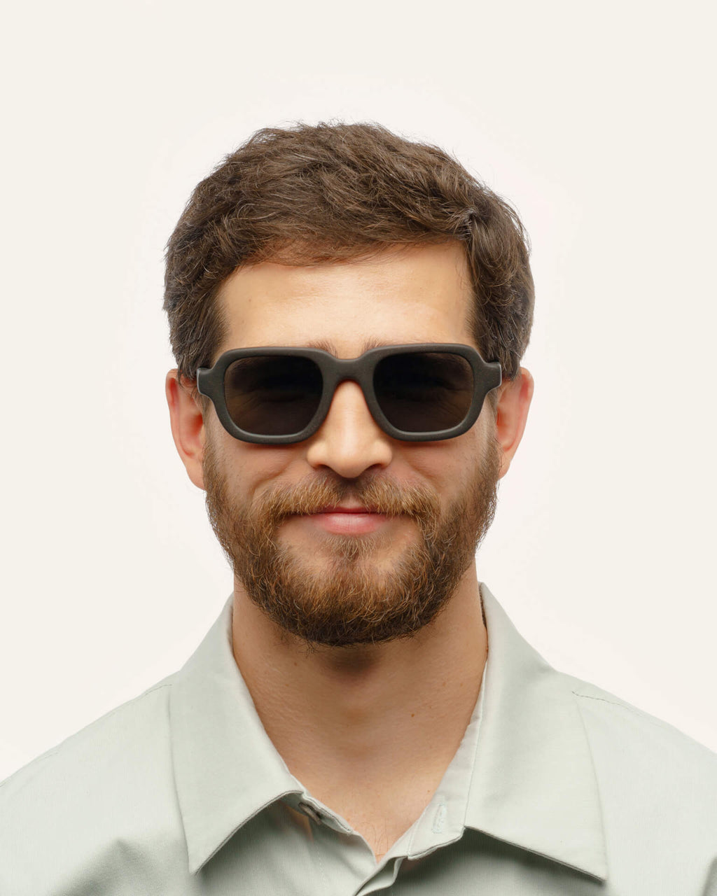 Man wearing Ochis Brade sunglasses, showcasing their modern square design and sustainable materials