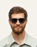 Man wearing Ochis Brade sunglasses, showcasing their modern square design and sustainable materials