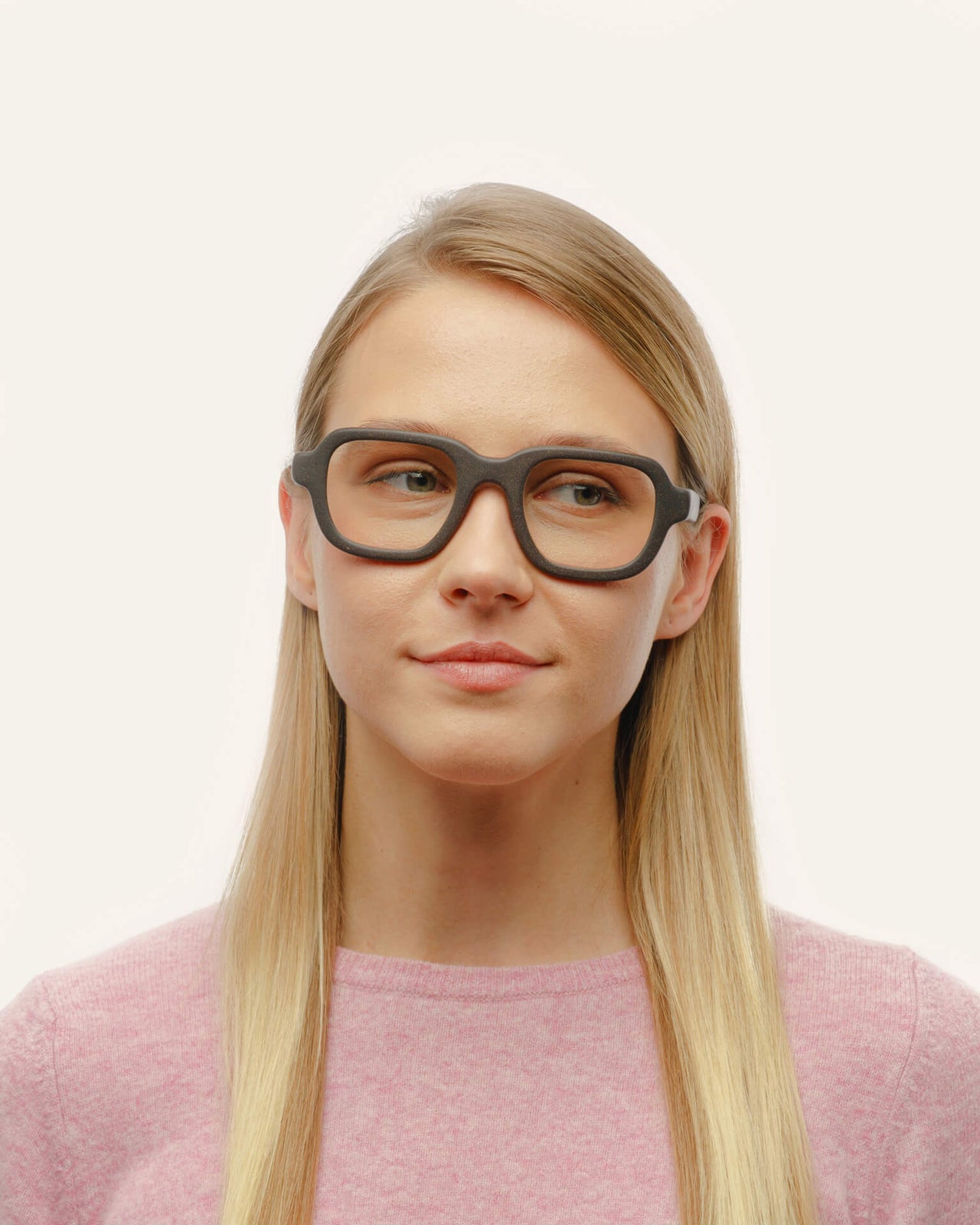 Load image into Gallery viewer, A woman modeling coffee-based optical glasses with clear lenses, emphasizing a minimalist and sustainable look.
