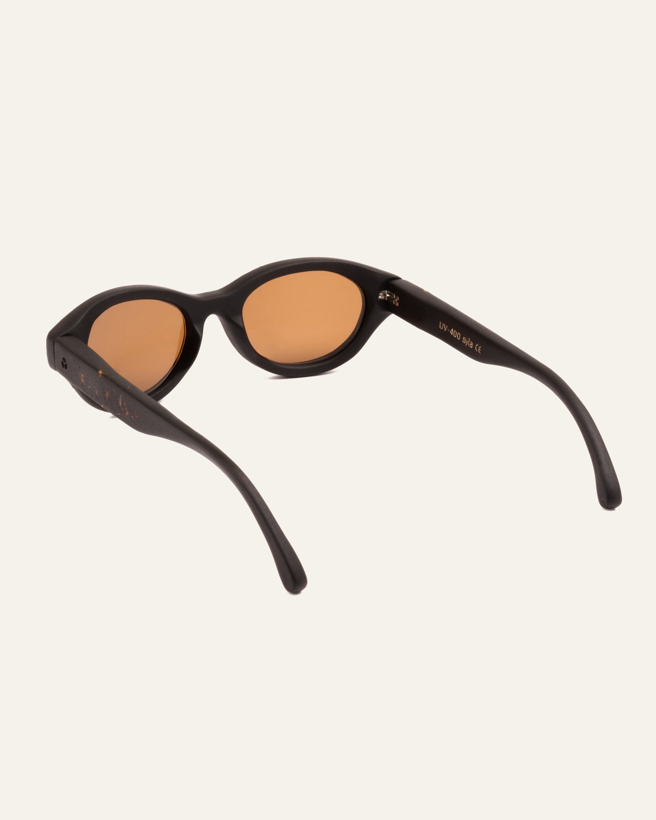 Load image into Gallery viewer, Angled view of biodegradable sunglasses with marigold petal highlights and brown polarized lenses
