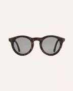 Front view of Kole Krasa sunglasses with gray polarized lenses and coffee-based frames adorned with light-blue cornflower petals