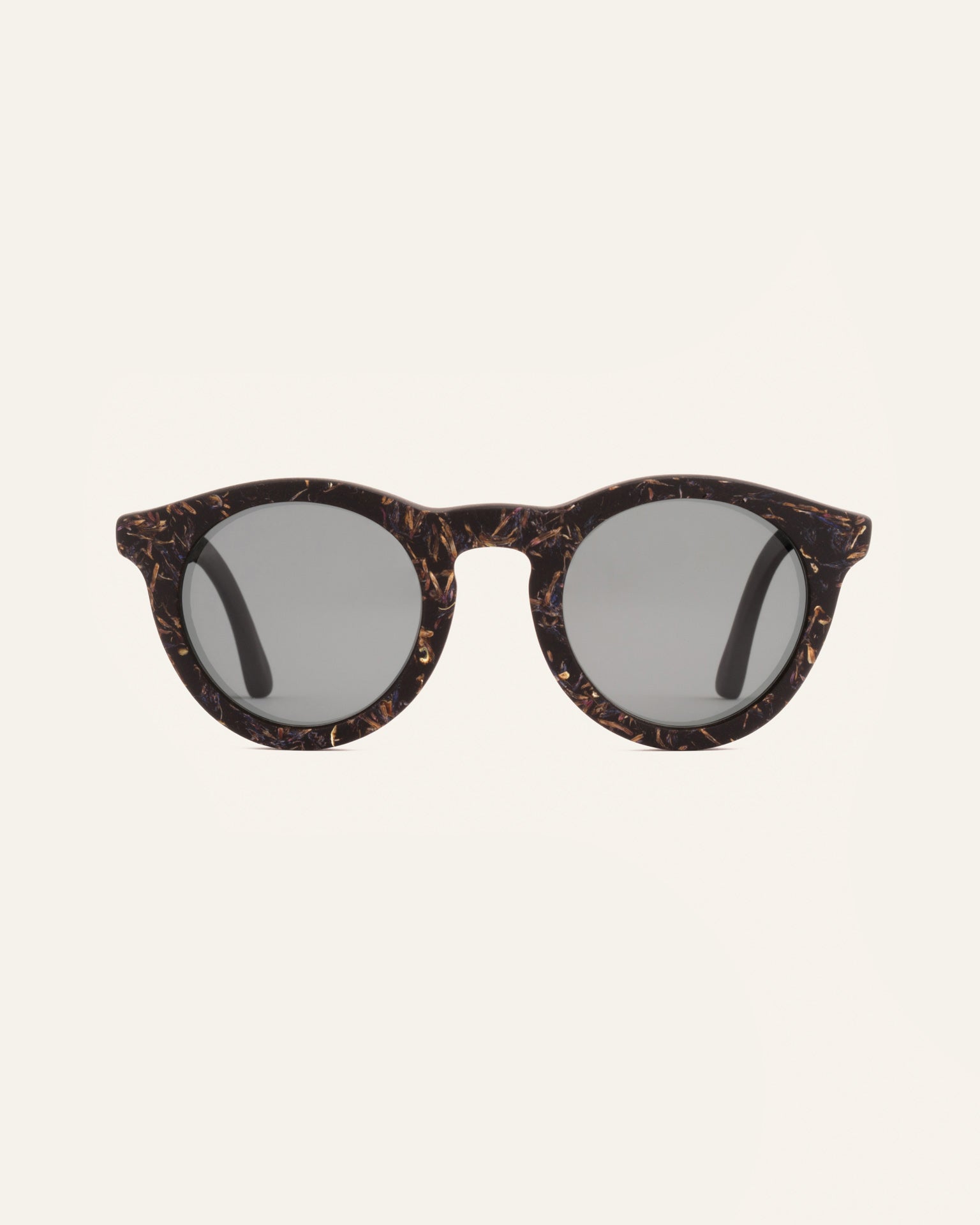 Front view of Kole Krasa sunglasses with gray polarized lenses and coffee-based frames adorned with light-blue cornflower petals