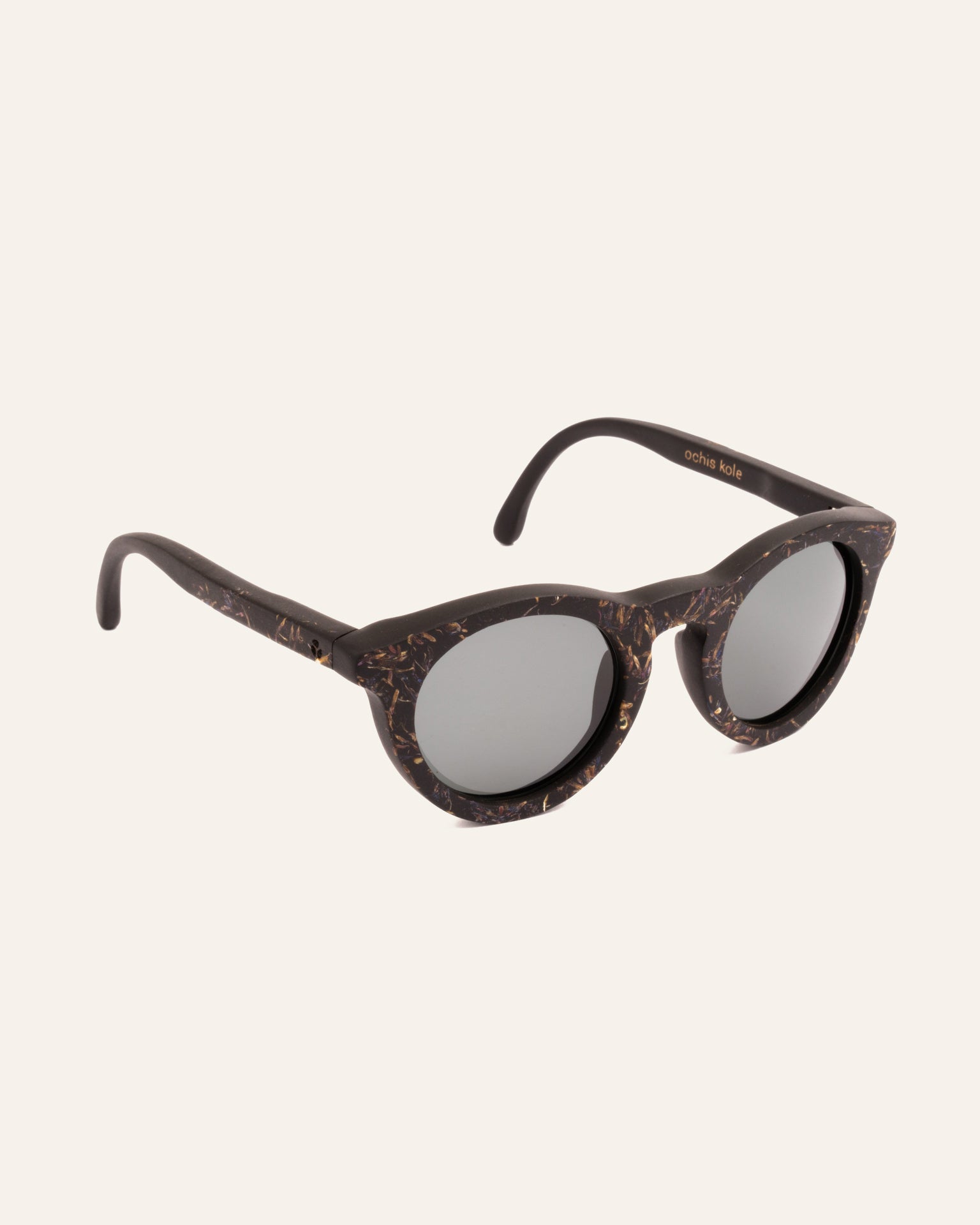Angled view of Kole Krasa sunglasses with gray lenses, featuring natural blue cornflower accents and sustainable craftsmanship
