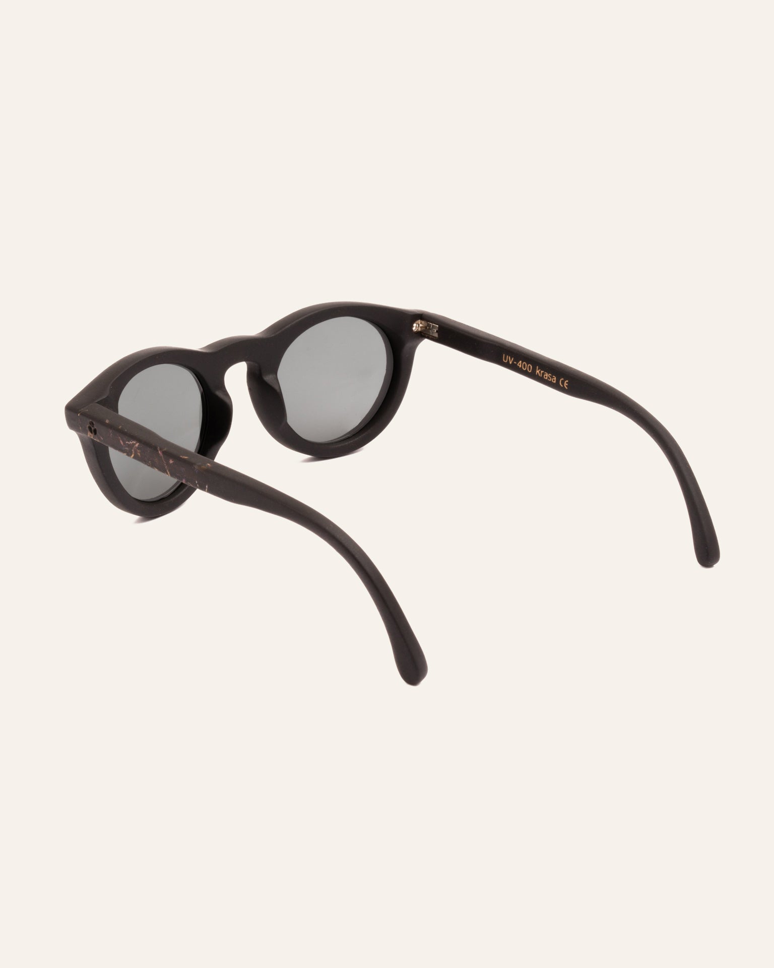 Side view of Kole Krasa sunglasses, emphasizing the delicate blue petal details on the coffee-based frame