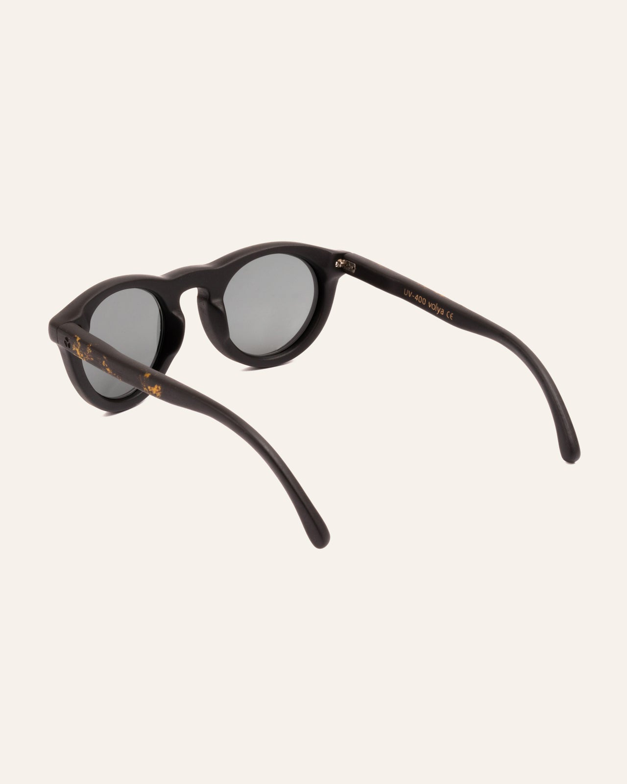 Load image into Gallery viewer, Angled close-up of Kole Volya sunglasses, featuring gray lenses and natural coffee-based frames with sunflower-inspired texture
