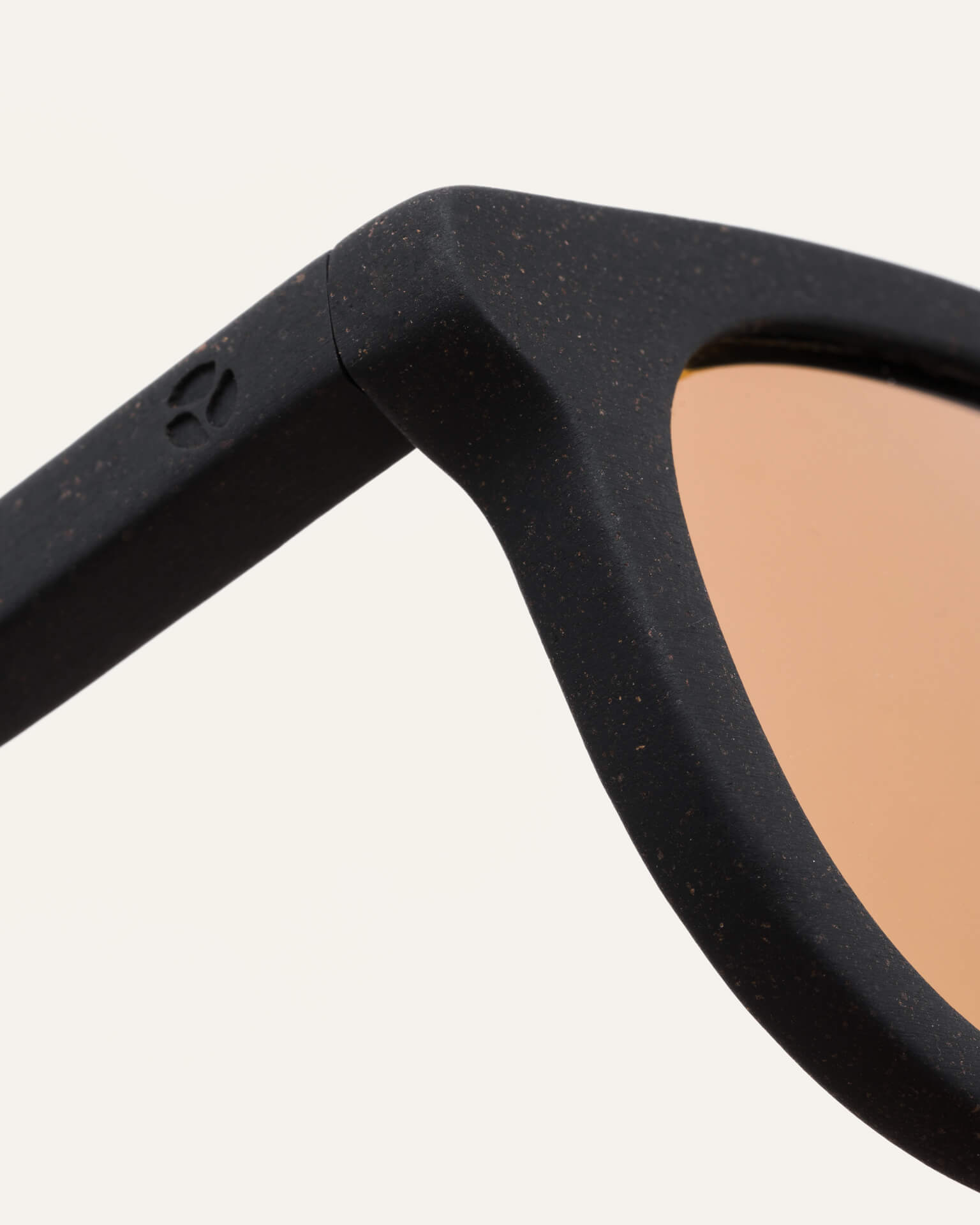 Close-up of Anderson Black sunglasses with brown lenses, showing the smooth coffee-based frame finish