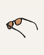 Angled view of modern sunglasses with brown lenses, perfect for sunny days.