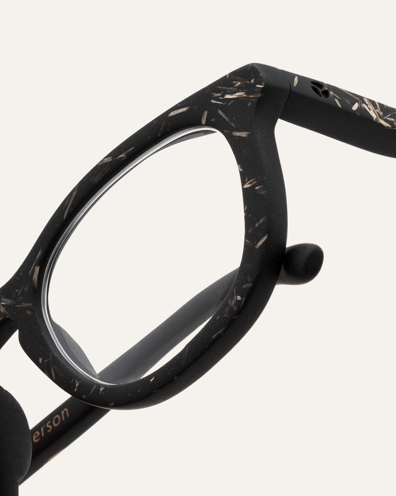 Close-up of natural-textured eyewear, showcasing its minimalist design and eco materials.