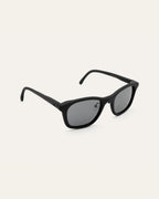 Side view of minimalist black sunglasses with gray lenses, showcasing their plastic-free design for daily use in Europe.