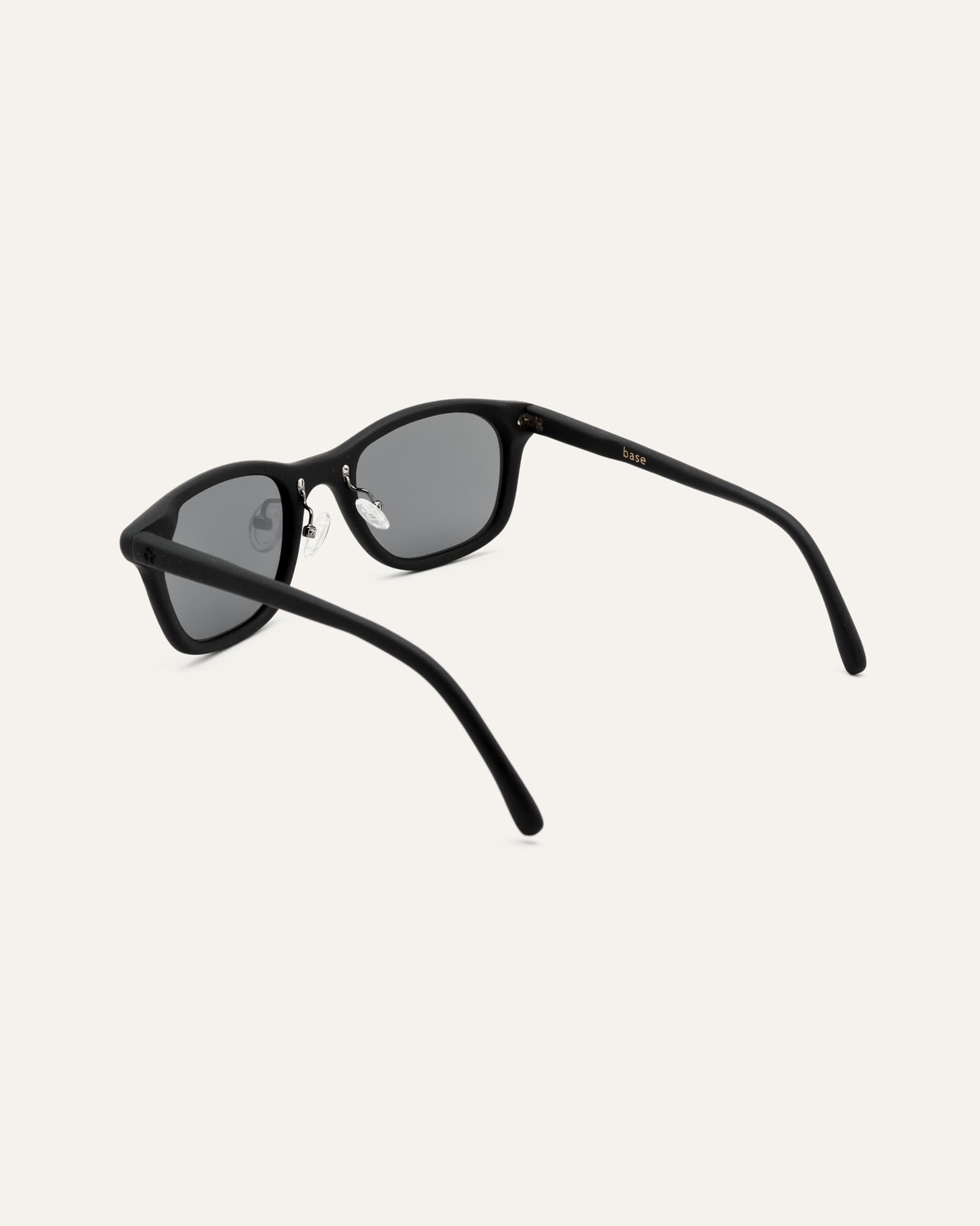 Detailed view of eco-friendly sunglasses with gray lenses, crafted from coffee-based materials for travel enthusiasts.