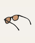 Detailed view of sunglasses with flax straw-infused frames and brown lenses, highlighting their natural design.
