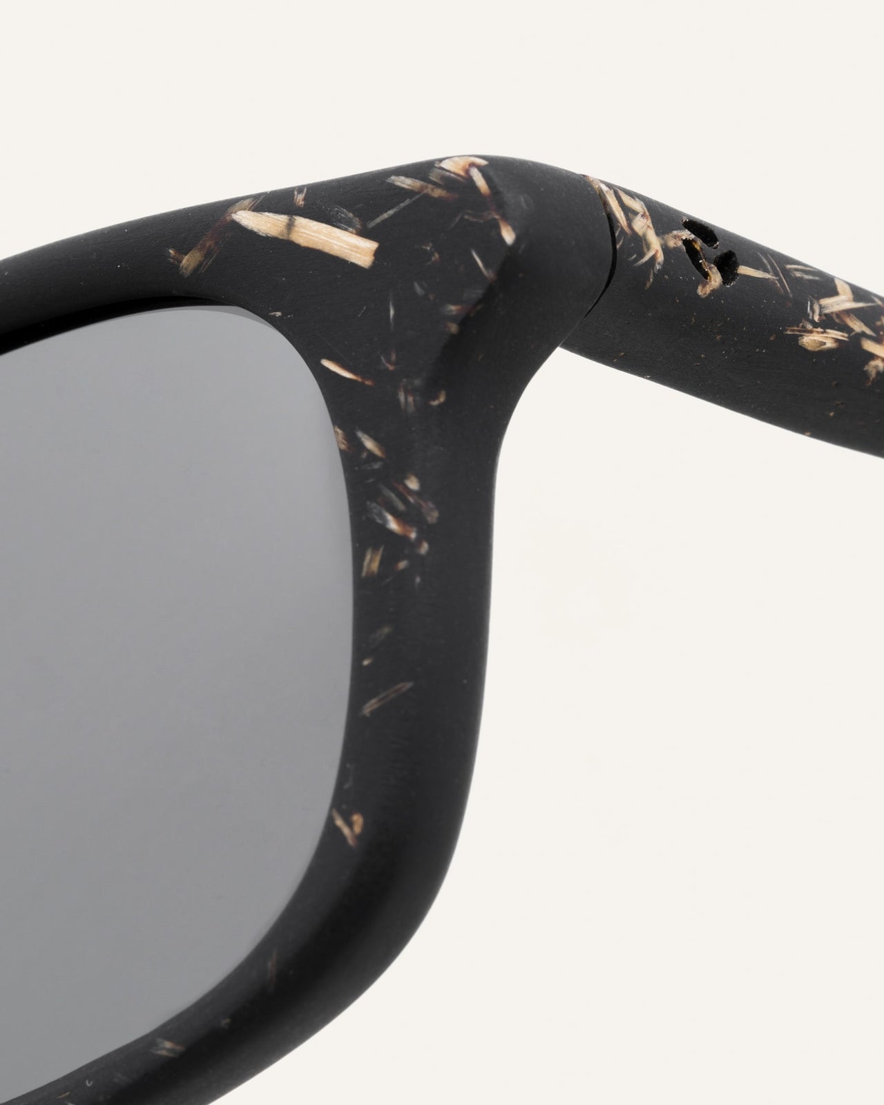 Load image into Gallery viewer, Close-up of black sunglasses frame, featuring intricate flax textures and eco-conscious materials.
