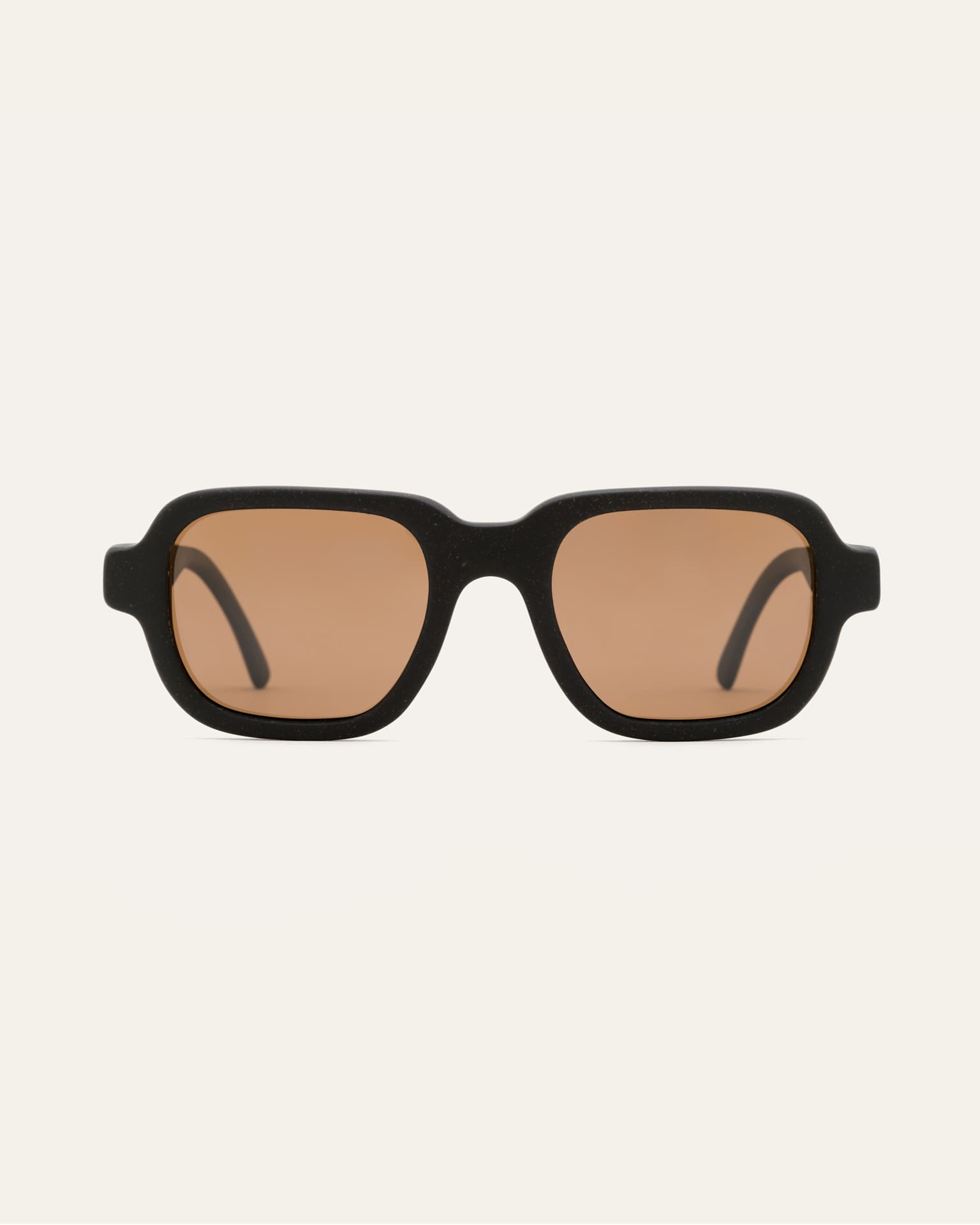 Ochis Brade sunglasses with warm brown lenses, crafted from coffee-based materials, displayed on a clean background.