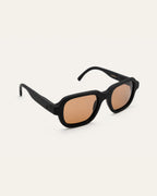 Side view of a black bold sunglasses made of coffee