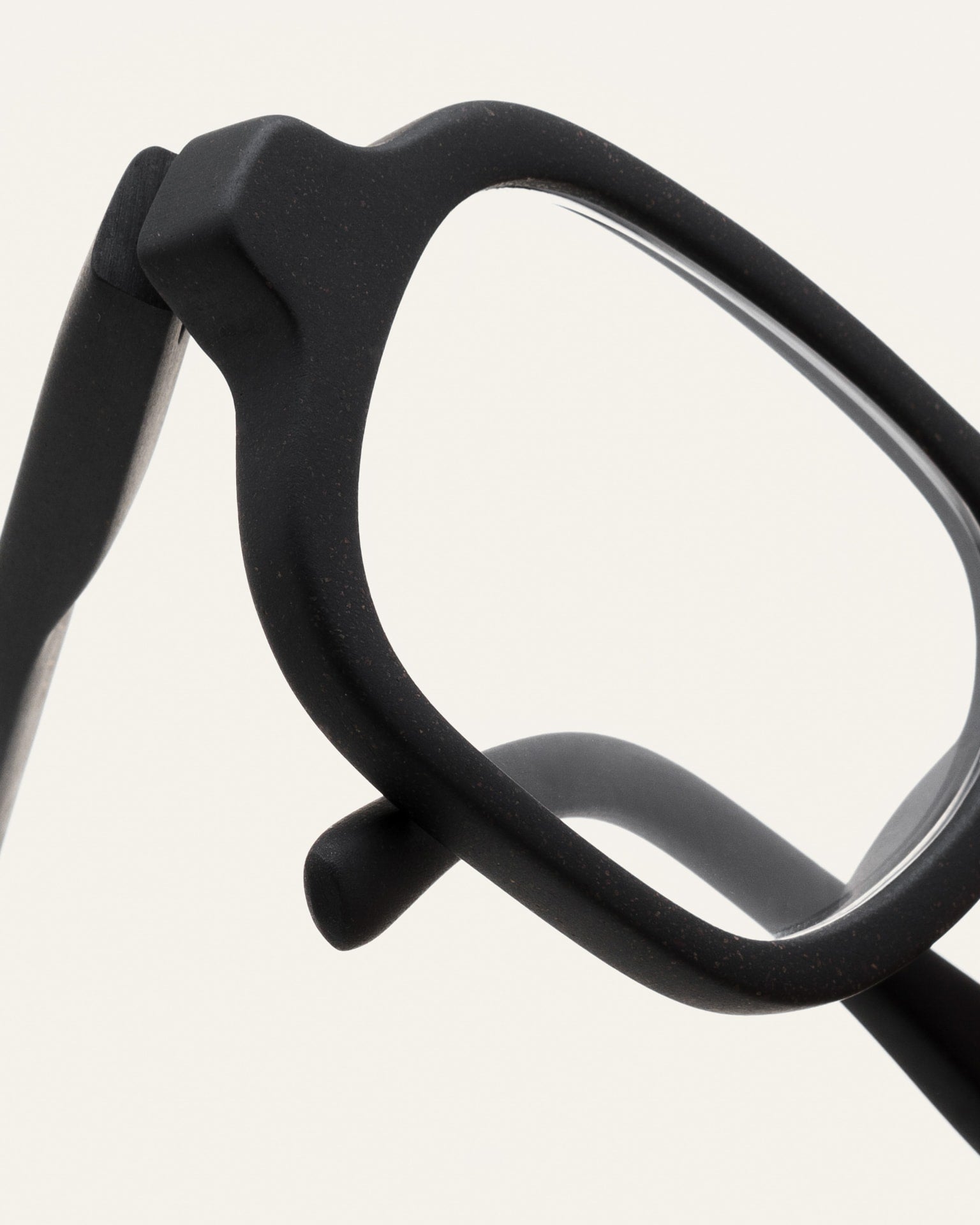 Close-up of black frames made from coffee grounds, highlighting the smooth finish and natural craftsmanship.